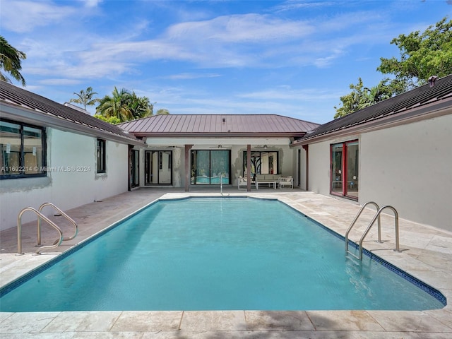 view of pool with a patio area and ceiling fan