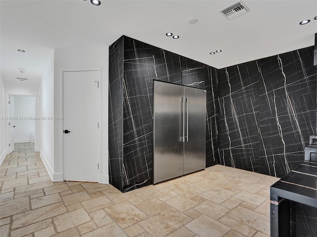 bathroom with tile walls