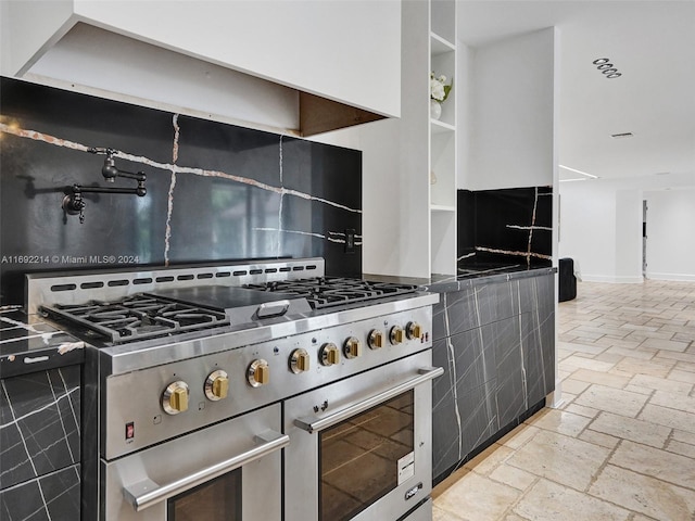 kitchen featuring backsplash and high end stainless steel range