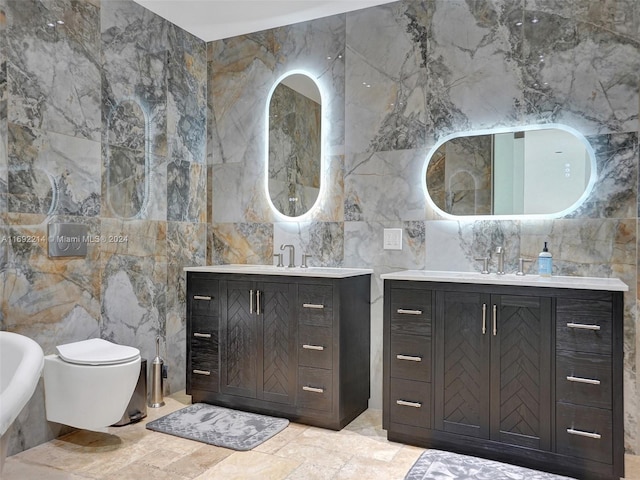 bathroom with vanity, tile walls, and toilet