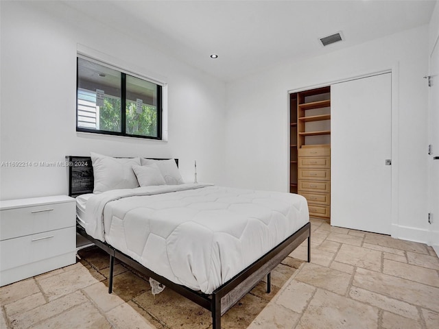 bedroom featuring a spacious closet and a closet