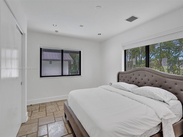 bedroom featuring multiple windows