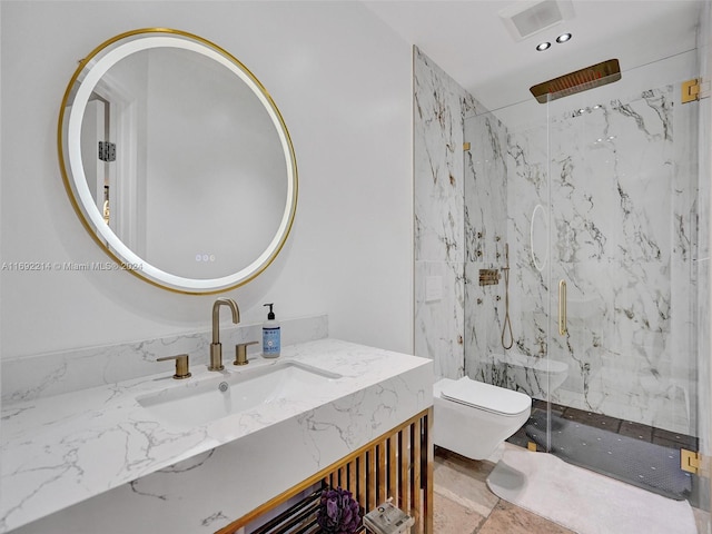 bathroom with vanity, toilet, and a shower with door