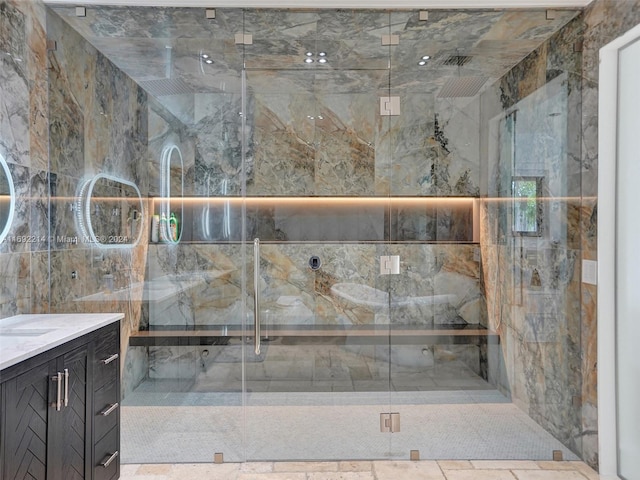 bathroom with vanity and a shower with shower door