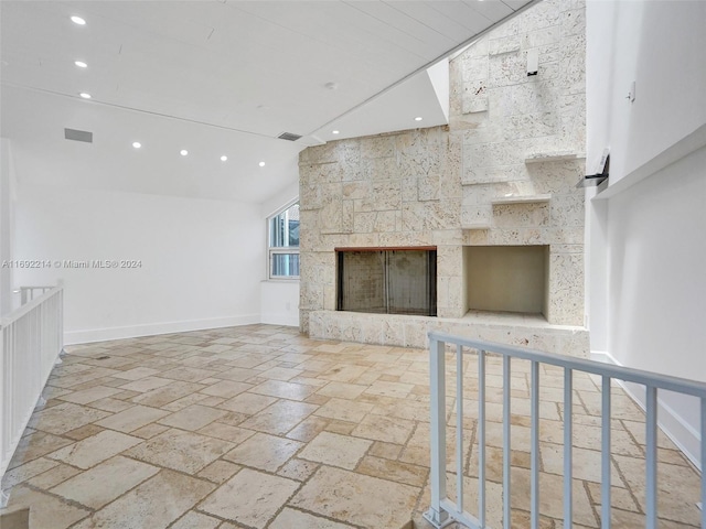 unfurnished living room featuring a large fireplace