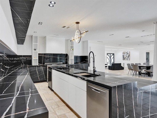 kitchen with pendant lighting, sink, stainless steel dishwasher, an island with sink, and white cabinetry