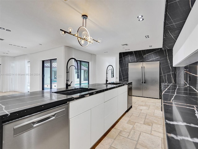 kitchen with backsplash, stainless steel appliances, white cabinetry, and sink