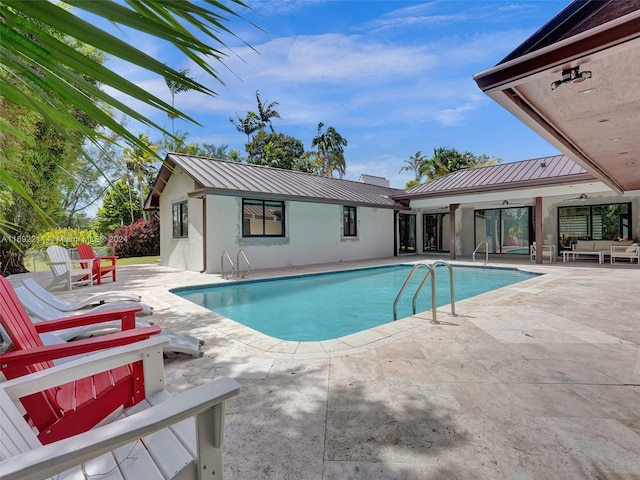 view of swimming pool with ceiling fan and a patio area