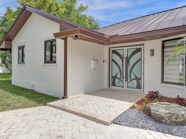 view of exterior entry featuring french doors