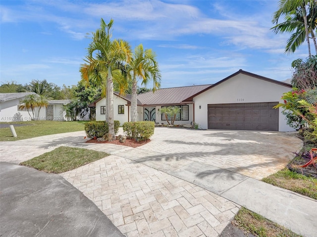 ranch-style home featuring a front yard and a garage