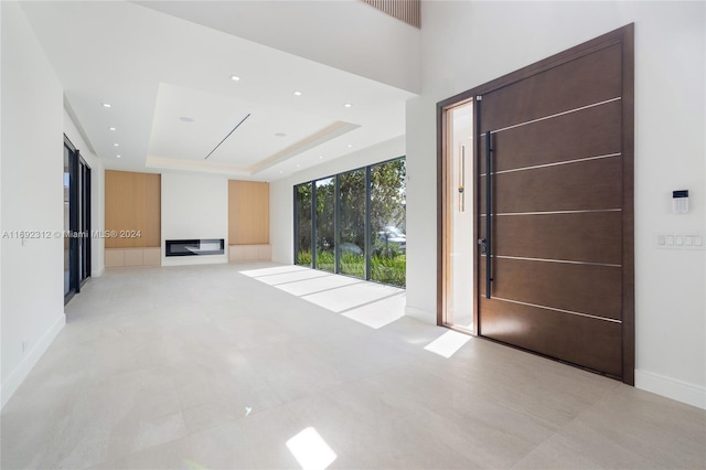 foyer with a raised ceiling