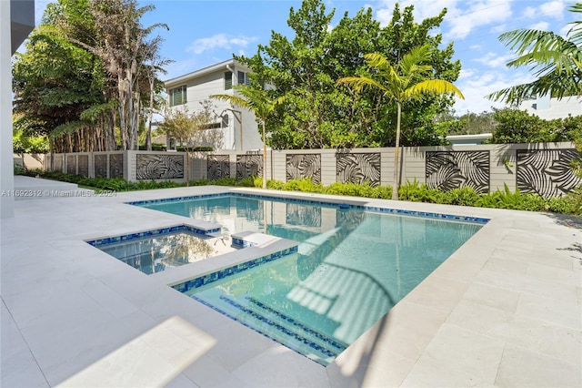 view of pool featuring a patio area and an in ground hot tub