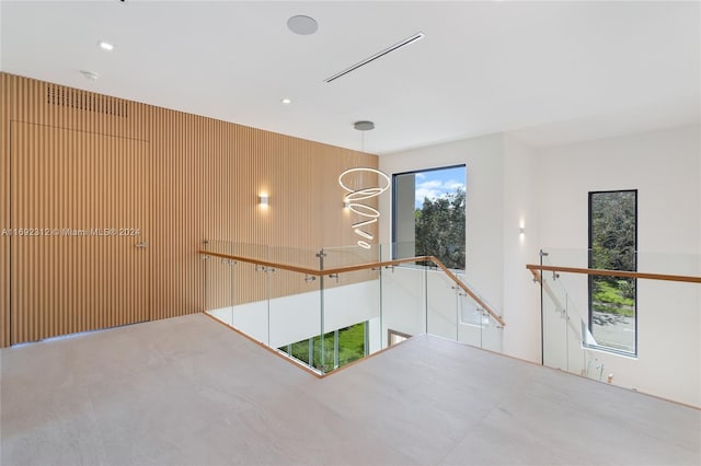 unfurnished room featuring wooden walls and concrete floors