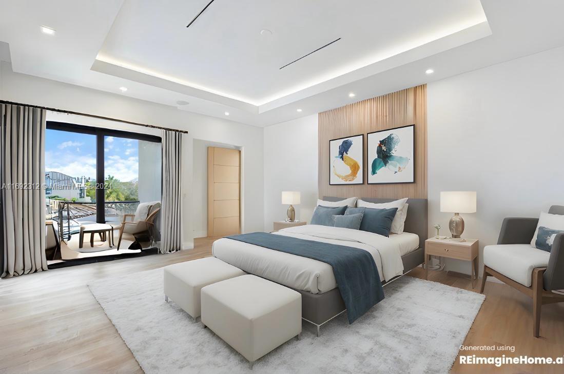 bedroom with a tray ceiling, access to exterior, and light hardwood / wood-style flooring