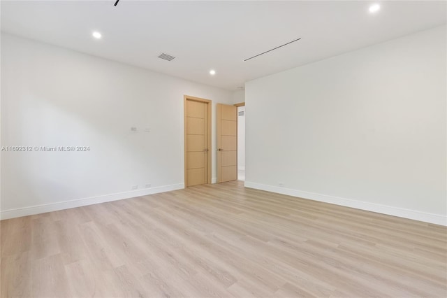 unfurnished room with light wood-type flooring