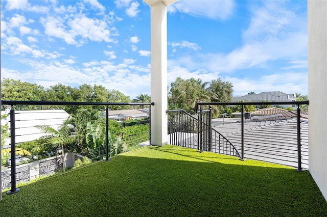 view of yard with a balcony