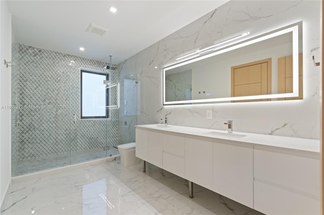 bathroom with vanity, toilet, and tiled shower