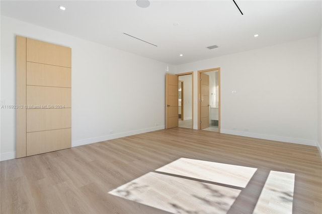 unfurnished room with light wood-type flooring