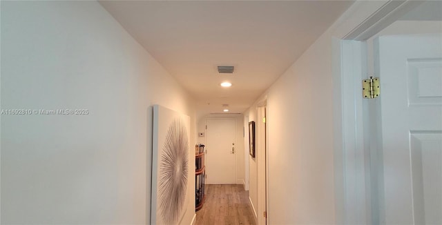 corridor with light hardwood / wood-style flooring