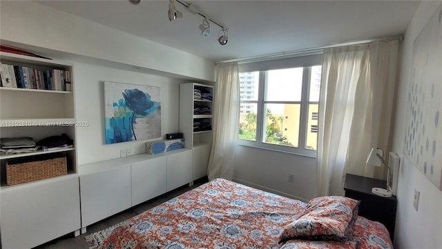 bedroom featuring track lighting