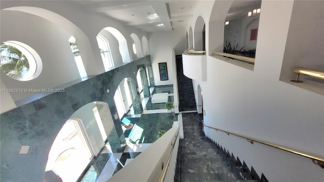 interior space featuring coffered ceiling and a towering ceiling