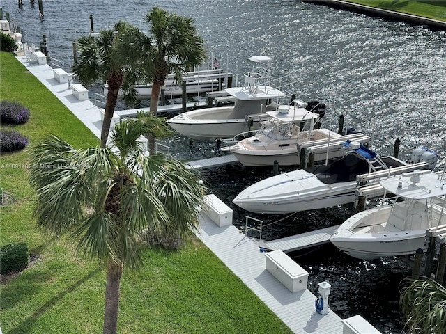 dock area featuring a water view and a lawn