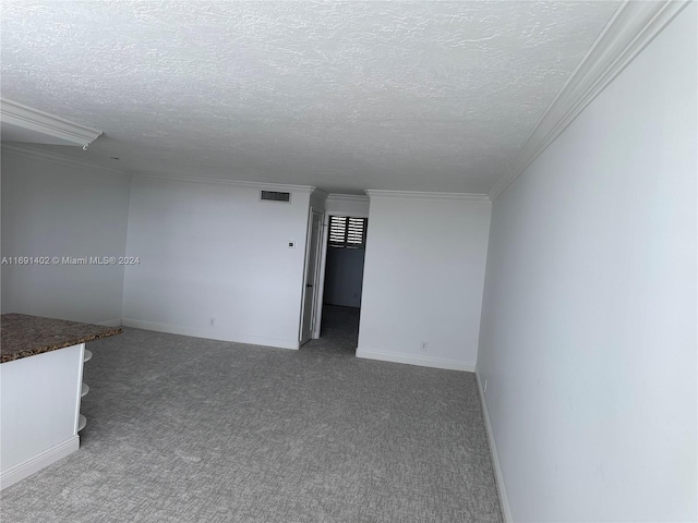 carpeted spare room featuring a textured ceiling and crown molding