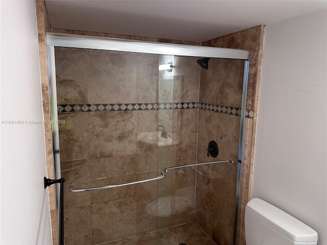 bathroom with walk in shower and toilet