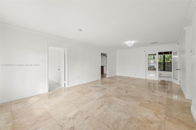 empty room featuring crown molding