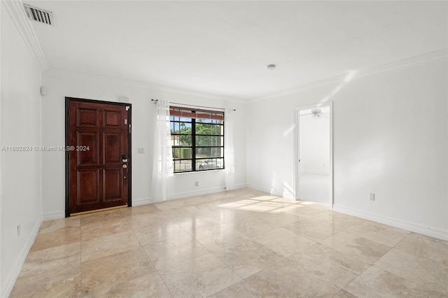 spare room featuring ceiling fan and crown molding