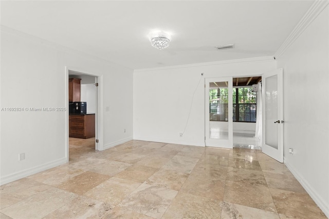 empty room featuring visible vents, baseboards, and ornamental molding