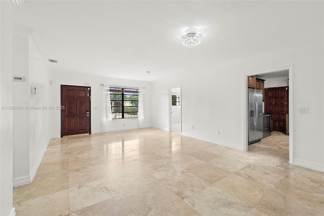 unfurnished room featuring baseboards, visible vents, and ornamental molding