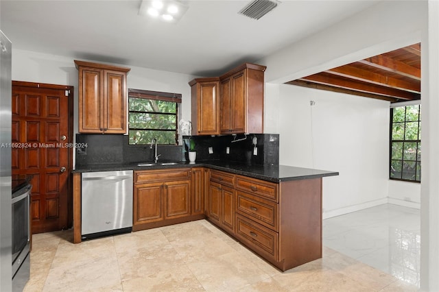 kitchen featuring backsplash, appliances with stainless steel finishes, sink, and a healthy amount of sunlight