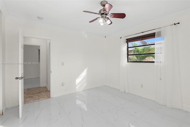 spare room with ornamental molding and ceiling fan