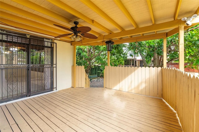 wooden terrace featuring fence and ceiling fan