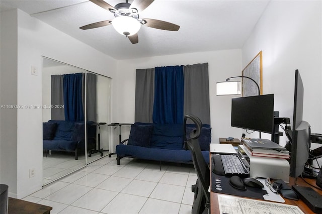 home office with light tile patterned floors and ceiling fan