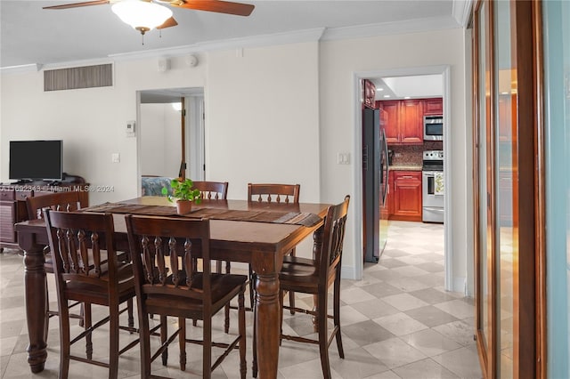 dining room with ceiling fan and ornamental molding