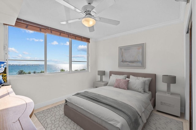 5005 Collins Ave Unit 615, Miami Beach, FL 33140 - bedroom featuring a water view, baseboards, ceiling fan, and crown molding