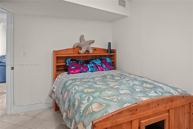 bedroom featuring light tile patterned flooring