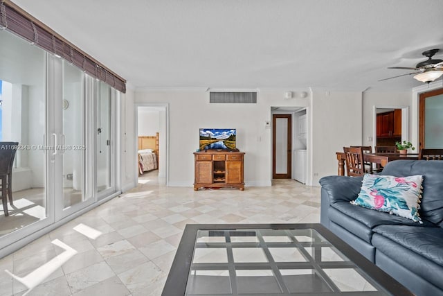 living room featuring crown molding and ceiling fan