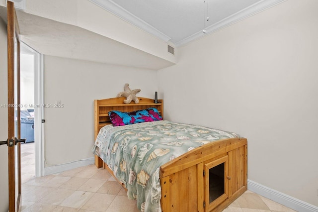 bedroom with light tile patterned floors and ornamental molding