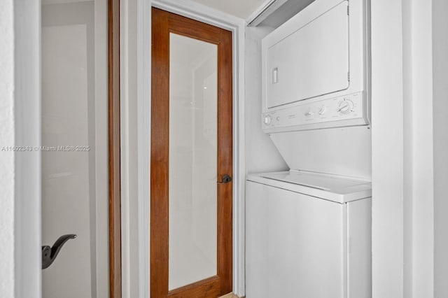 clothes washing area featuring stacked washer and dryer