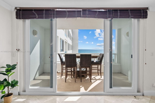 doorway to outside with a water view