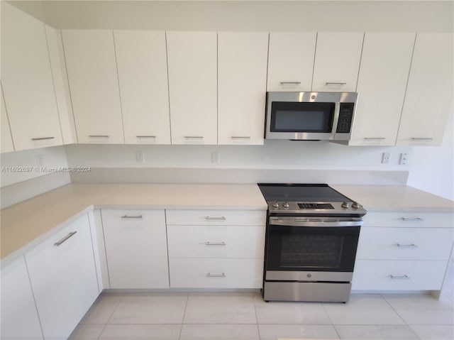 kitchen featuring white cabinetry, appliances with stainless steel finishes, and light tile patterned floors