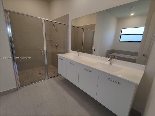 bathroom featuring vanity, independent shower and bath, and tile patterned flooring