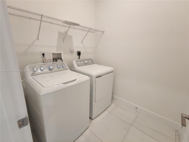 washroom with washer and dryer and light tile patterned floors