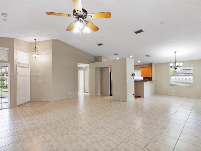 unfurnished living room featuring a textured ceiling, lofted ceiling, and ceiling fan with notable chandelier