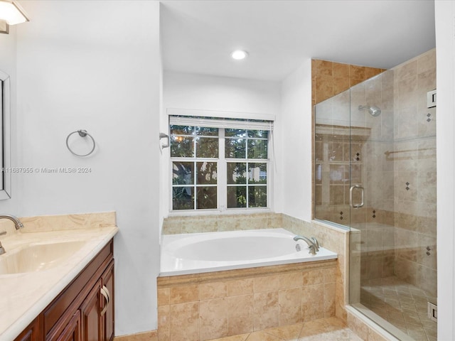 bathroom featuring tile patterned flooring, vanity, and separate shower and tub