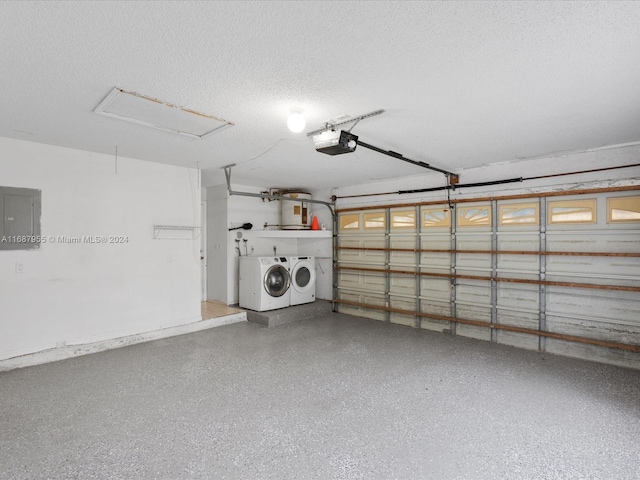 garage with electric panel, washer and clothes dryer, and a garage door opener