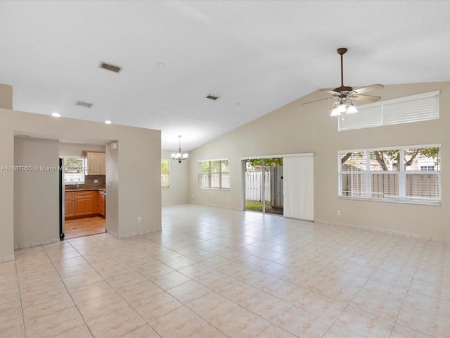 empty room featuring ceiling fan with notable chandelier, light tile patterned flooring, and high vaulted ceiling